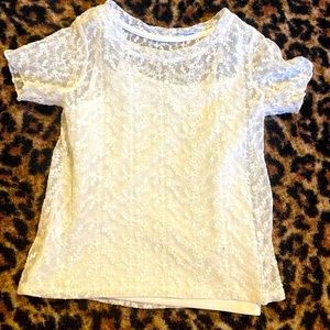 White floral sham top with white cameo attached underneath.